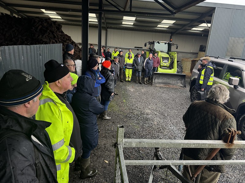 Farmers gather in a farm yard